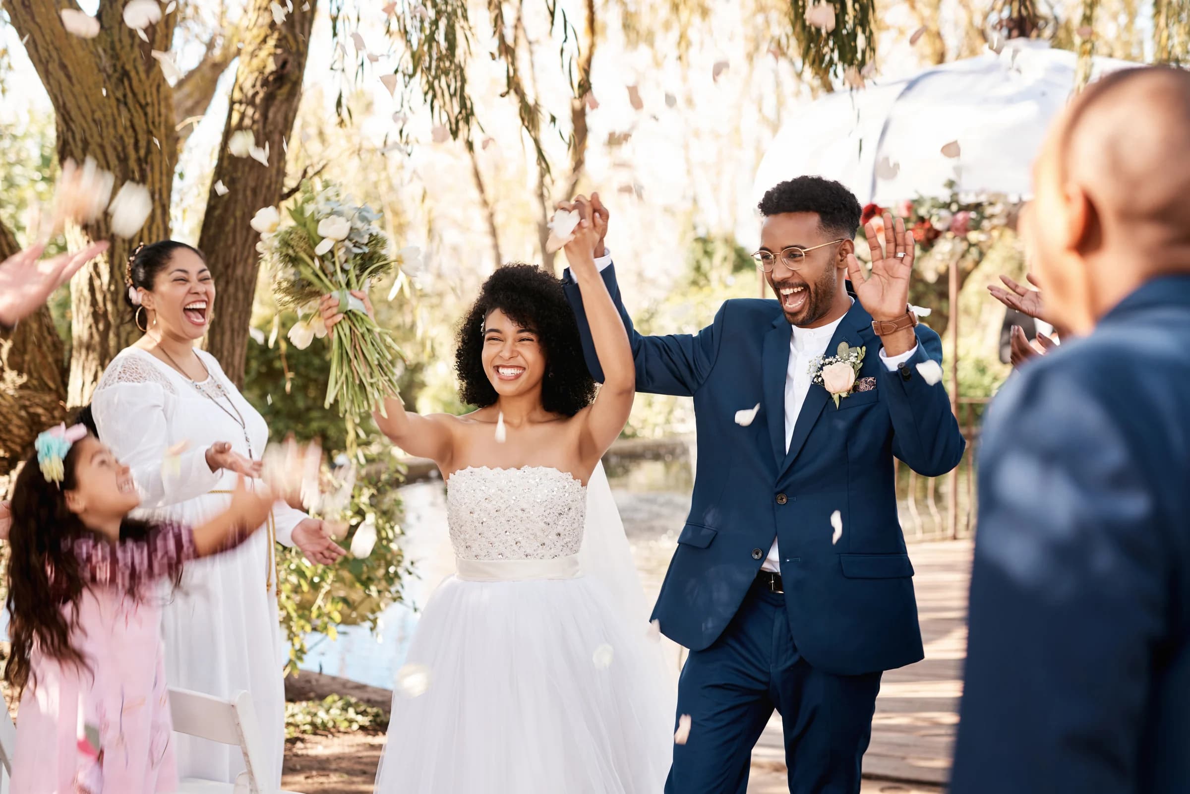 Couple and guests celebrating a wedding outdoors